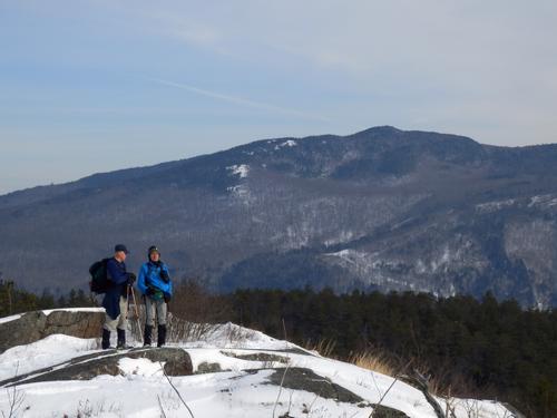 winter hikers and view of Stinson Mountain from Rattlesnake Mountain in New Hampshire