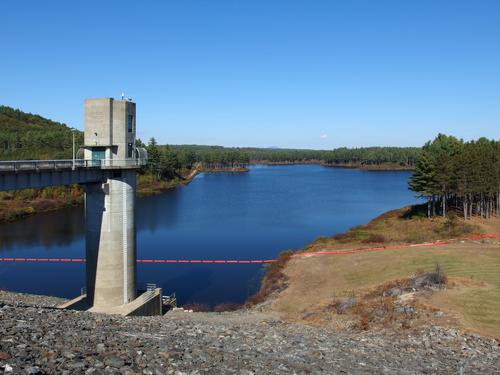 view of Everett Lake and its flood-control tower from the dam-top road adjacent to Clough State Park in southern New Hampshire