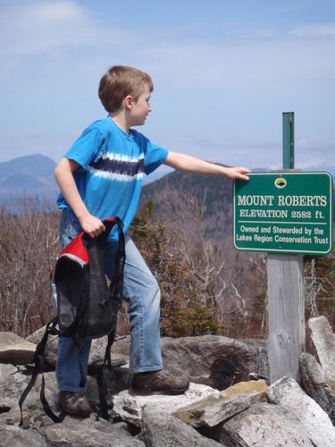 hiker at the summit of Mount Roberts in New Hampshire