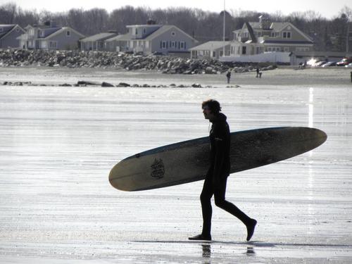 surfer at Cable Road Beach at Rye in New Hampshire