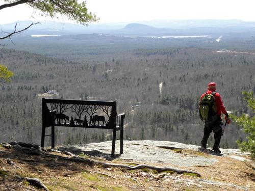 hiker at a viewpoint on Sabattus Mountain in Maine
