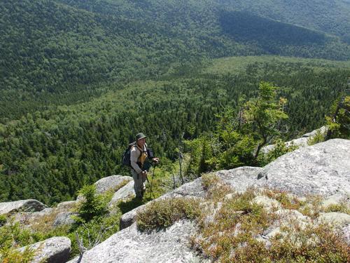 Dick walks along the precipitous cliff on the south side of Sachem Peak in the White Mountains of New Hampshire