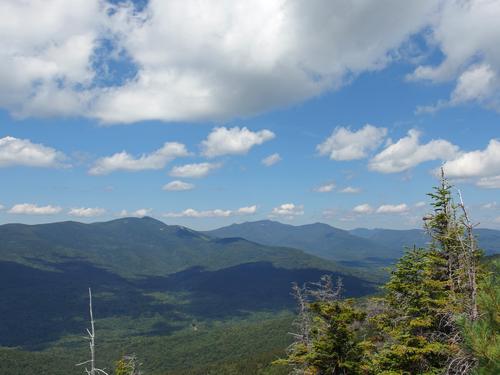 view of Mount Tecumseh (with a few ski slopes showing) and the farther Osceolas from Sachem Peak in the White Mountains of New Hampshre