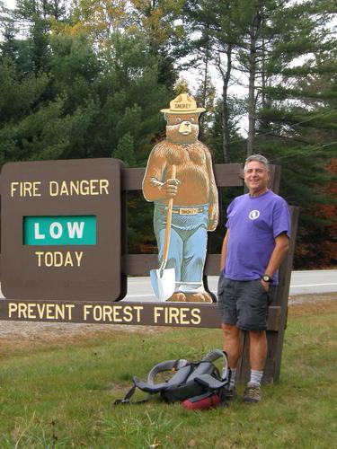 hiker and Smokey the Bear sign in New Hampshire