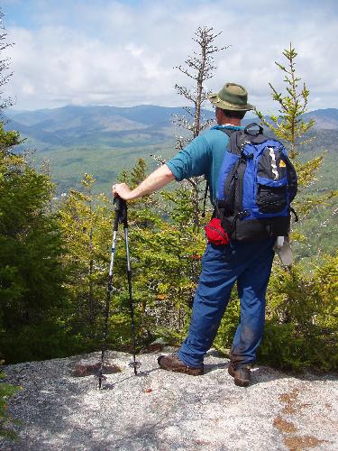 hiker and view from a lookout near Noon Peak in New Hampshire