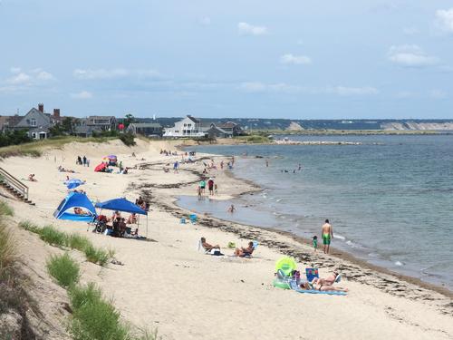 Sandwich Beach at the far end of Sandwich Boardwalk, with Cape Cod Bay to the right and the Cape Cod Canal 
in the background just beyond the houses