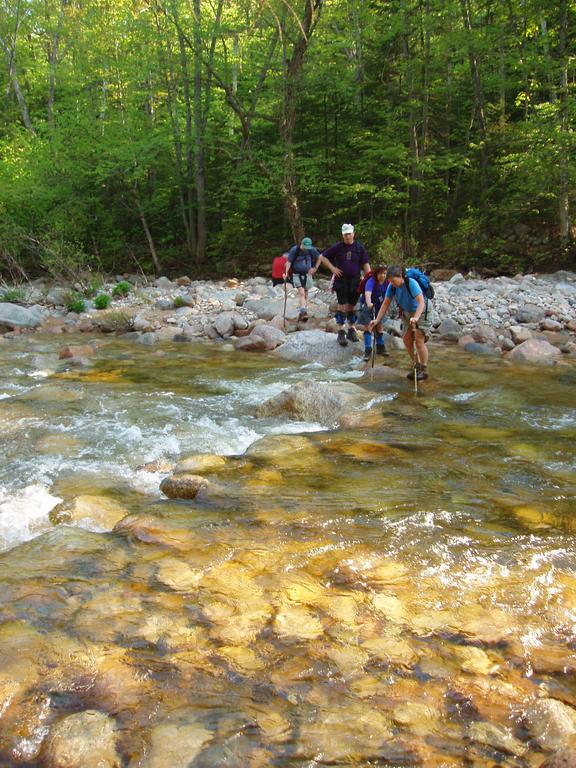 hikers crossing Hancock Branch on the way to West Scar Ridge in New Hampshire