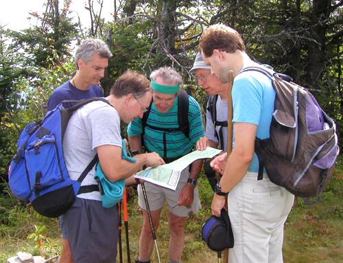 hikers checking the trail map on Mount Shaw in New Hampshire
