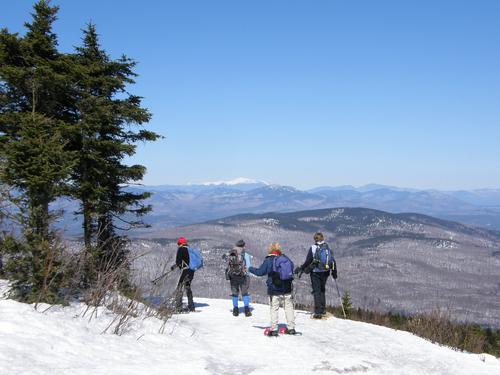 hikers in March on the summit of Mount Shaw in New Hampshire