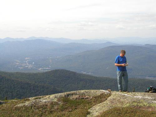 hiker and view from Shelburne Moriah Mountain in New Hampshire