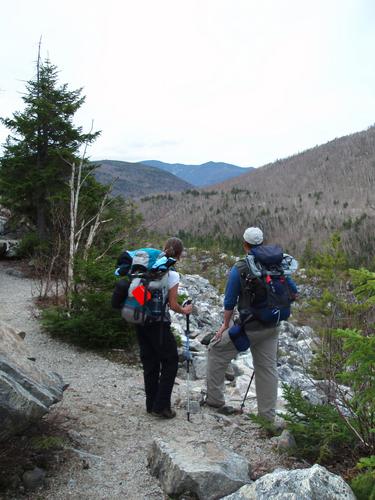 hikers on the trail to Shoal Pond Peak in New Hampshire