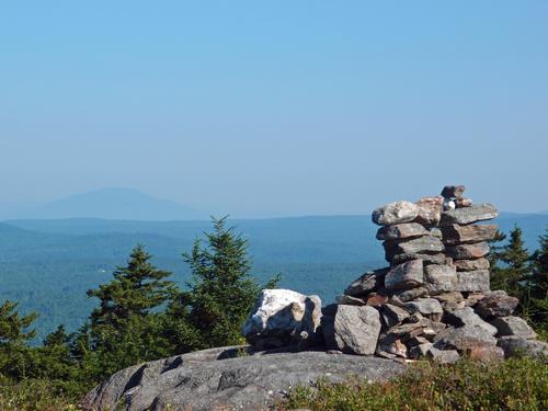 view of Mount Ascutney in Vermont and the summit cairn from Silver Mountain in New Hampshire