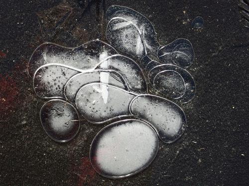 curvy ice art on a driveway in January after a rain/freeze weather combination in southern New Hampshire