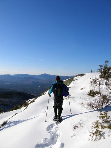 winter hiker on the trail to Middle Sister Mountain in New Hampshire