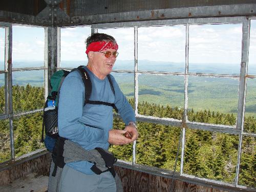 hiker in the fire tower on Smarts Mountain in New Hampshire