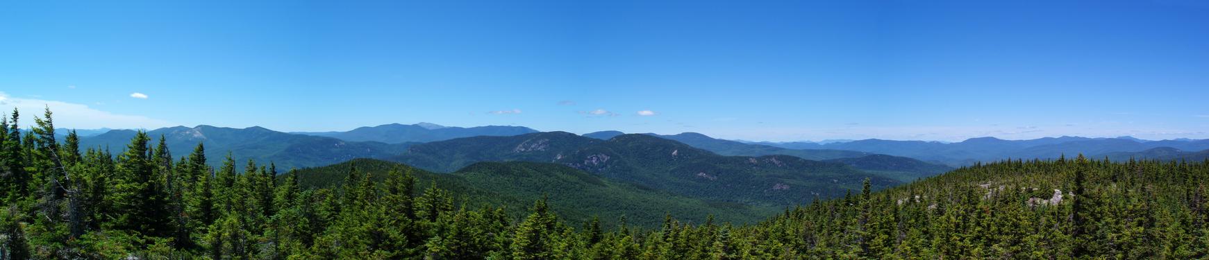 panoramic view in June of New Hampshire's northern mountains from Speckled Mountain in Maine