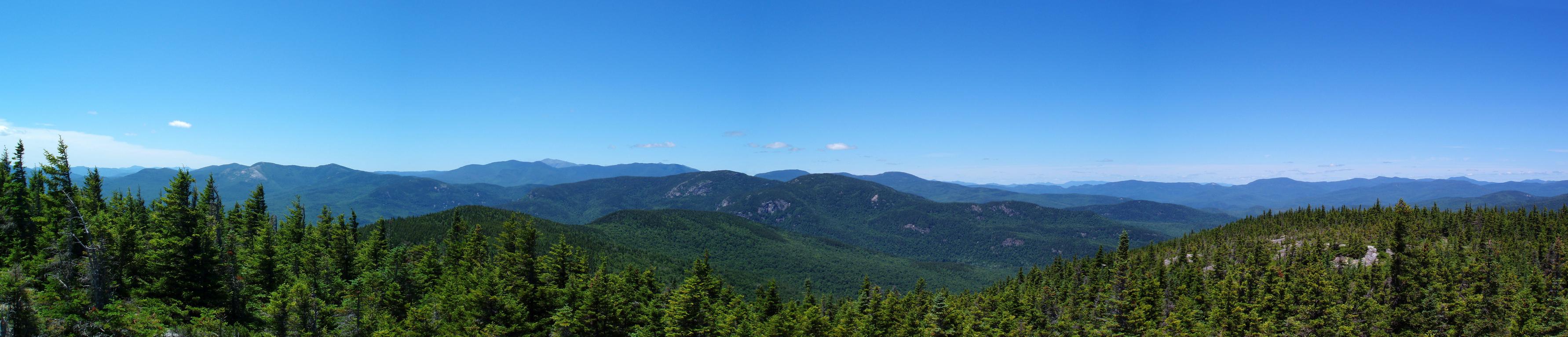 panoramic view in June of New Hampshire's northern mountains from Speckled Mountain in Maine