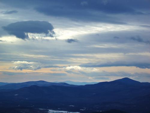 dramatic-weather view in January of Kearsarge North mountain as seen from Speckled Mountain in western Maine