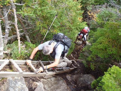 hikers ascending flimsy ladders on the trail to Big Spencer Mountain in Maine