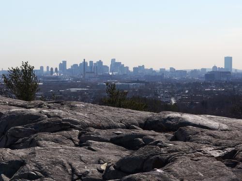 view of the Boston Skyline from Boojum Rock near Spot Pond at Middlesex Fells Reservation in eastern Massachusetts