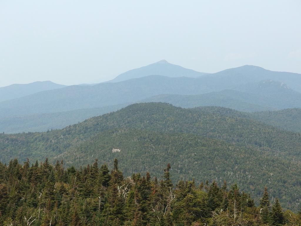 view of Molly Stark Mountain (near bump) and Camel's Hump (far pointy peak) 
from the panorama viewpoint on Stark Mountain in northern Vermont