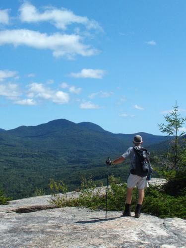 hiker on the summit of Middle Sugarloaf Mountain in New Hampshire