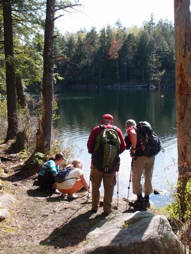 hikers at Goose Pond below Sugarloaf Mountain near Newfound Lake in New Hampshire