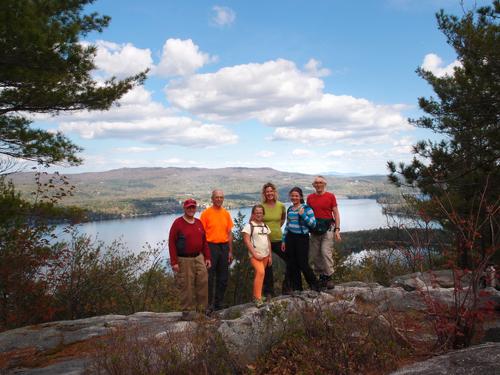 hikers on the summit of Sugarloaf Mountain near Newfound Lake in New Hampshire
