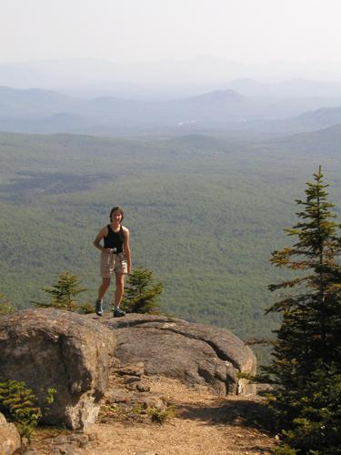 hiker and view from Sugarloaf Mountain in New Hampshire