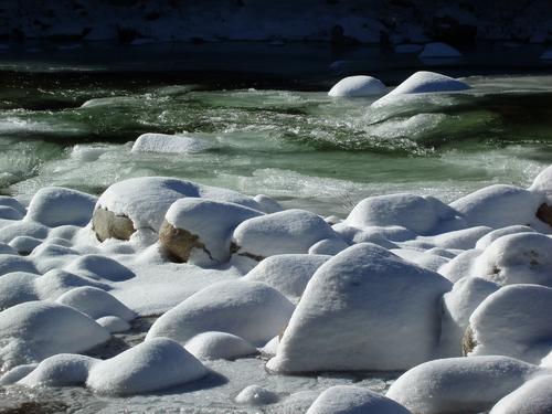 snow-covered boulders in Mad River in New Hampshire