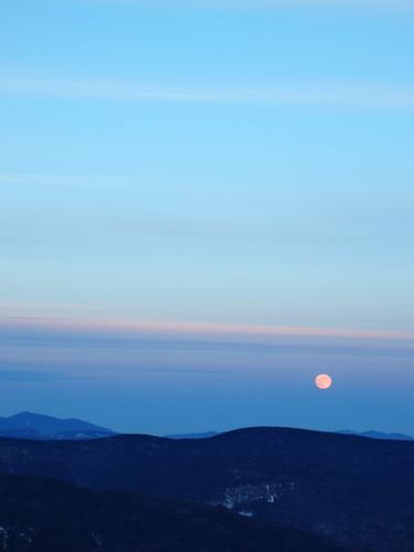 moonrise in December over Mount Kancamagus as seen from Mount Tecumseh in New Hampshire