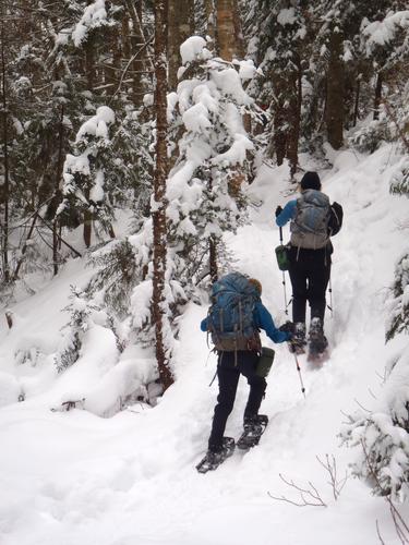 winter hikers on the trail to Mount Tecumseh in New Hampshire