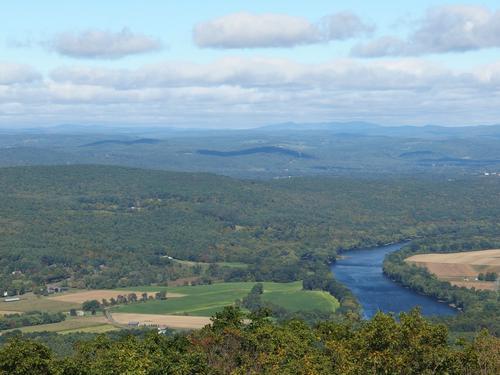 view of distant Mount Snow and Stratton Mountain in Vermont, with the Connecticut River in the foreground, as seen from the Sunderland Fire Tower atop Mount Toby in western Massachusetts