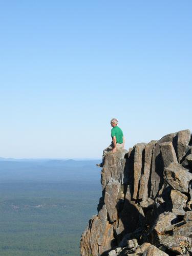 Fred sits out on the edge of Peak of the Ridges on Traveler Mountain in northern Maine