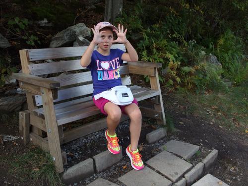 Talia on a trailside bench on the hike to Wachusett Mountain in Massachusetts