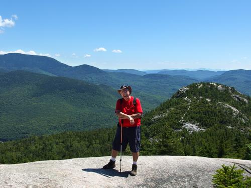 Jerry near the summit of Dickey Mountain with a background view of Welch Mountain in New Hampshire