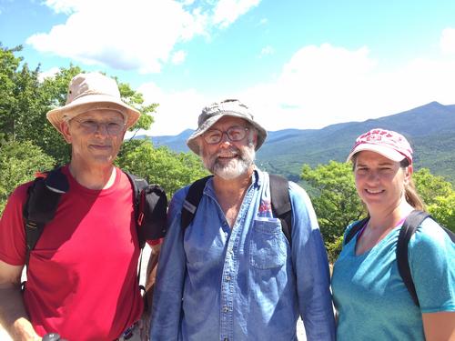 three hikers near the summit of Welch Mountain in New Hampshire