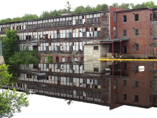 abandoned factory and reflection illusion beside the Northern Rail Trail east of Lebanon in New Hampshire