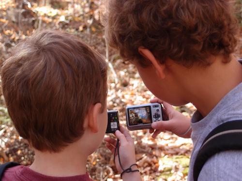 young hikers check their photos on the trail to Mount Whiteface in the Sandwich Range in New Hampshire