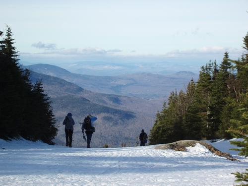 hikers headed down a ski trail on Wildcat Mountain in New Hampshire