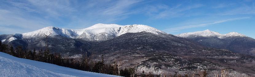 panoramic view of the Northern Presidentail Mountains in January as seen from Wildcat Mountain in New Hampshire