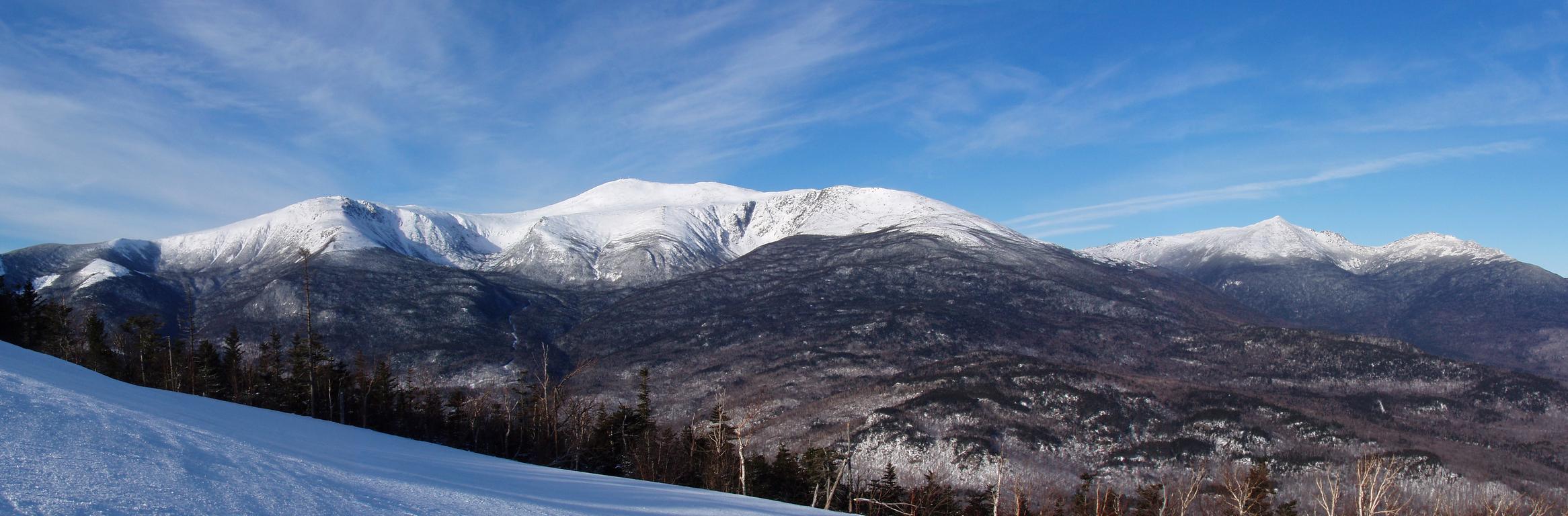 panoramic view of the Northern Presidentail Mountains in January as seen from Wildcat Mountain in New Hampshire