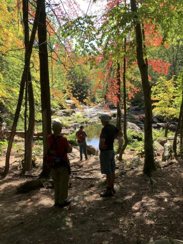 a group of hikers in fall at Wildcat Falls in southern New Hampshire
