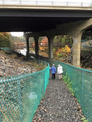 Elaine and Andee walk under the Everett Turnpike near Wildcat Falls in southern New Hampshire
