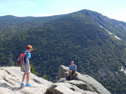 Carl and Linda on Mount Willard's ledge with Mount Webster in the background in New Hampshire