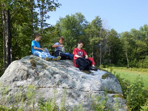 young hikers on a snack rock on the way to Winslow Ledge in New Hampshire