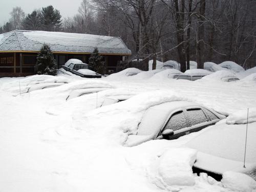 snow-buried cars in March near Lincoln in New Hampshire