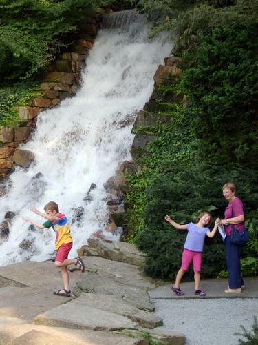kids messing around at the Chimes Tower waterfall at Longwood Gardens in Pennsylvania