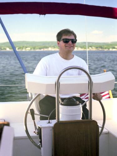 Jimmy steers our sailboat along the coast of Maine in July 1997
