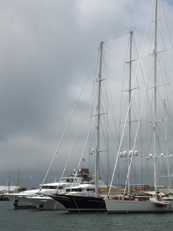 fancy boats lined up before a storm-threatening sky at Newport in Rhode Island